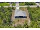 New construction home features a screened lanai, a metal roof, and minimal landscaping at 15613 Alsask Cir, Port Charlotte, FL 33981