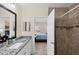 Bathroom with a granite vanity, tiled shower, and a peek into the adjacent bedroom at 15613 Alsask Cir, Port Charlotte, FL 33981