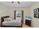 Shared bedroom with two beds, a dresser with a TV, and neutral decor at 15613 Alsask Cir, Port Charlotte, FL 33981