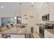 Bright kitchen with a granite countertop island, stainless steel appliances, and pendant lighting at 15613 Alsask Cir, Port Charlotte, FL 33981