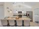 Well-lit kitchen featuring a granite countertop island with seating and stainless steel appliances at 15613 Alsask Cir, Port Charlotte, FL 33981