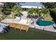 Waterfront property featuring a private dock, boat lift, and patio perfect for enjoying the water views at 1648 Shelburne Ln, Sarasota, FL 34231