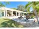 Beautiful waterfront home featuring an outdoor patio with fire pit, seating, and stunning views at 1648 Shelburne Ln, Sarasota, FL 34231