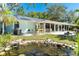 Backyard with pond, patio and tropical landscaping at 1648 Shelburne Ln, Sarasota, FL 34231