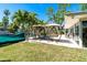 Backyard with swing chairs, palm trees, and boat dock access, ideal for waterfront living at 1648 Shelburne Ln, Sarasota, FL 34231