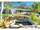 Backyard with pond, patio and tropical landscaping at 1648 Shelburne Ln, Sarasota, FL 34231