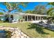 The backyard features a serene pond, outdoor kitchen, fire pit, and an expansive patio that's great for entertaining or relaxing at 1648 Shelburne Ln, Sarasota, FL 34231