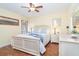 Cozy bedroom with hardwood floors, ceiling fan, and plenty of natural light at 1648 Shelburne Ln, Sarasota, FL 34231