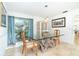 Bright dining room featuring a unique glass-top table with a driftwood base at 1648 Shelburne Ln, Sarasota, FL 34231
