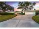 Well-maintained home exterior with a spacious driveway and lush green lawn, creating curb appeal and a welcoming entrance at 1648 Shelburne Ln, Sarasota, FL 34231