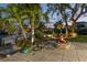 Outdoor seating area with a brick fire pit and beautiful water views enhanced by lush landscaping and palm trees at 1648 Shelburne Ln, Sarasota, FL 34231