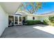 Home exterior featuring an arched doorway and lush landscaping at 1648 Shelburne Ln, Sarasota, FL 34231