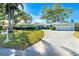 Charming single-story home with well-manicured lawn, mature landscaping, and a two-car garage at 1648 Shelburne Ln, Sarasota, FL 34231