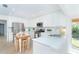 Bright, updated kitchen with white cabinets, stainless steel appliances, and an island with breakfast bar seating at 1648 Shelburne Ln, Sarasota, FL 34231