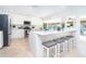 Bright open kitchen with center island, counter seating, and stainless steel appliances at 1648 Shelburne Ln, Sarasota, FL 34231