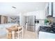 Modern white kitchen with tile flooring, stainless steel appliances, and breakfast nook at 1648 Shelburne Ln, Sarasota, FL 34231