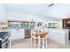 Open concept kitchen with modern appliances, bright white cabinets, and eat-in breakfast area at 1648 Shelburne Ln, Sarasota, FL 34231