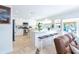 Modern kitchen with white cabinets, center island with seating, and stainless steel appliances at 1648 Shelburne Ln, Sarasota, FL 34231