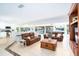 Open concept living area with tile flooring, kitchen island seating and access to the outdoor patio at 1648 Shelburne Ln, Sarasota, FL 34231