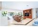Spacious open-concept living room featuring travertine floors and sliding glass doors to outdoor spaces at 1648 Shelburne Ln, Sarasota, FL 34231