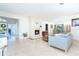 Bright living room with travertine floors, stone fireplace, and an abundance of natural light at 1648 Shelburne Ln, Sarasota, FL 34231