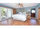 Serene main bedroom with a sliding door to the backyard, wood floors, and a ceiling fan at 1648 Shelburne Ln, Sarasota, FL 34231