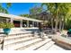 Charming patio area with steps, perfect for relaxation and outdoor dining, surrounded by beautiful landscaping at 1648 Shelburne Ln, Sarasota, FL 34231