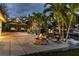 Outdoor patio area with fire pit, seating, swing chairs, and waterfront access, perfect for entertaining at 1648 Shelburne Ln, Sarasota, FL 34231
