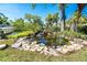 Backyard pond with tropical landscaping at 1648 Shelburne Ln, Sarasota, FL 34231