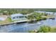 Aerial view of a house with a pool and boat dock by the river with boat at 18610 Ayrshire, Port Charlotte, FL 33981