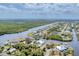Overhead view of coastal community with winding canals, lush greenery and properties with waterfront access at 18610 Ayrshire, Port Charlotte, FL 33981