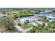 High-angle view of a property with canal access and dock, surrounded by lush green landscapes at 18610 Ayrshire, Port Charlotte, FL 33981