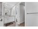 Well-lit bathroom with a large mirror above the sink, white cabinets, and a separate toilet room for privacy at 18610 Ayrshire, Port Charlotte, FL 33981