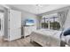 Comfortable bedroom with water views from a large window, light-colored furniture, and neutral decor at 18610 Ayrshire, Port Charlotte, FL 33981