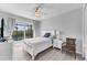 Bright bedroom with waterfront views from sliding doors, white furniture, ceiling fan, and serene decor at 18610 Ayrshire, Port Charlotte, FL 33981