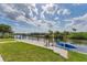 Waterfront property with a dock, kayak, and grassy lawn at 18610 Ayrshire, Port Charlotte, FL 33981