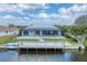 Exterior of home featuring private dock, backyard, and enclosed pool at 18610 Ayrshire, Port Charlotte, FL 33981