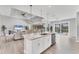 Kitchen island with bar seating overlooking the living room and screened-in lanai with pool views at 18610 Ayrshire, Port Charlotte, FL 33981