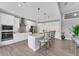 Modern kitchen with sleek white cabinetry, stainless steel appliances, and a spacious center island with seating at 18610 Ayrshire, Port Charlotte, FL 33981