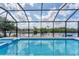 Beautiful pool area with clear blue water, screened enclosure, and scenic waterfront views for relaxation at 18610 Ayrshire, Port Charlotte, FL 33981