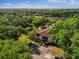 Aerial view of property in a lush, green, wooded area at 19505 Quesada Ave # B202, Port Charlotte, FL 33948