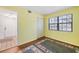 Bedroom with hardwood floor, area rug and a window providing natural light at 19505 Quesada Ave # B202, Port Charlotte, FL 33948