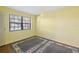 Bedroom with hardwood floor, area rug and a window providing natural light at 19505 Quesada Ave # B202, Port Charlotte, FL 33948