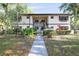 Charming two-story condo with well-maintained landscaping and inviting walkway at 19505 Quesada Ave # B202, Port Charlotte, FL 33948