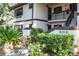 Exterior shot showcasing the condo building entrance and lush landscaping at 19505 Quesada Ave # B202, Port Charlotte, FL 33948