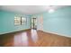 Living room with wood floors, neutral paint, and a sliding glass door at 19505 Quesada Ave # B202, Port Charlotte, FL 33948