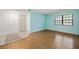Freshly painted living room featuring wood flooring and a bright window at 19505 Quesada Ave # B202, Port Charlotte, FL 33948