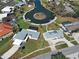 Aerial shot highlighting the home, its lush landscaping, the private pool, and the serene waterfront location at 202 South Dr, Englewood, FL 34223