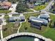 Aerial view showcases waterfront properties, lush landscaping, private docks, and serene canal access in a vibrant community at 202 South Dr, Englewood, FL 34223