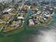 Stunning aerial view of waterfront property with private dock, lush landscaping, and access to open water at 202 South Dr, Englewood, FL 34223